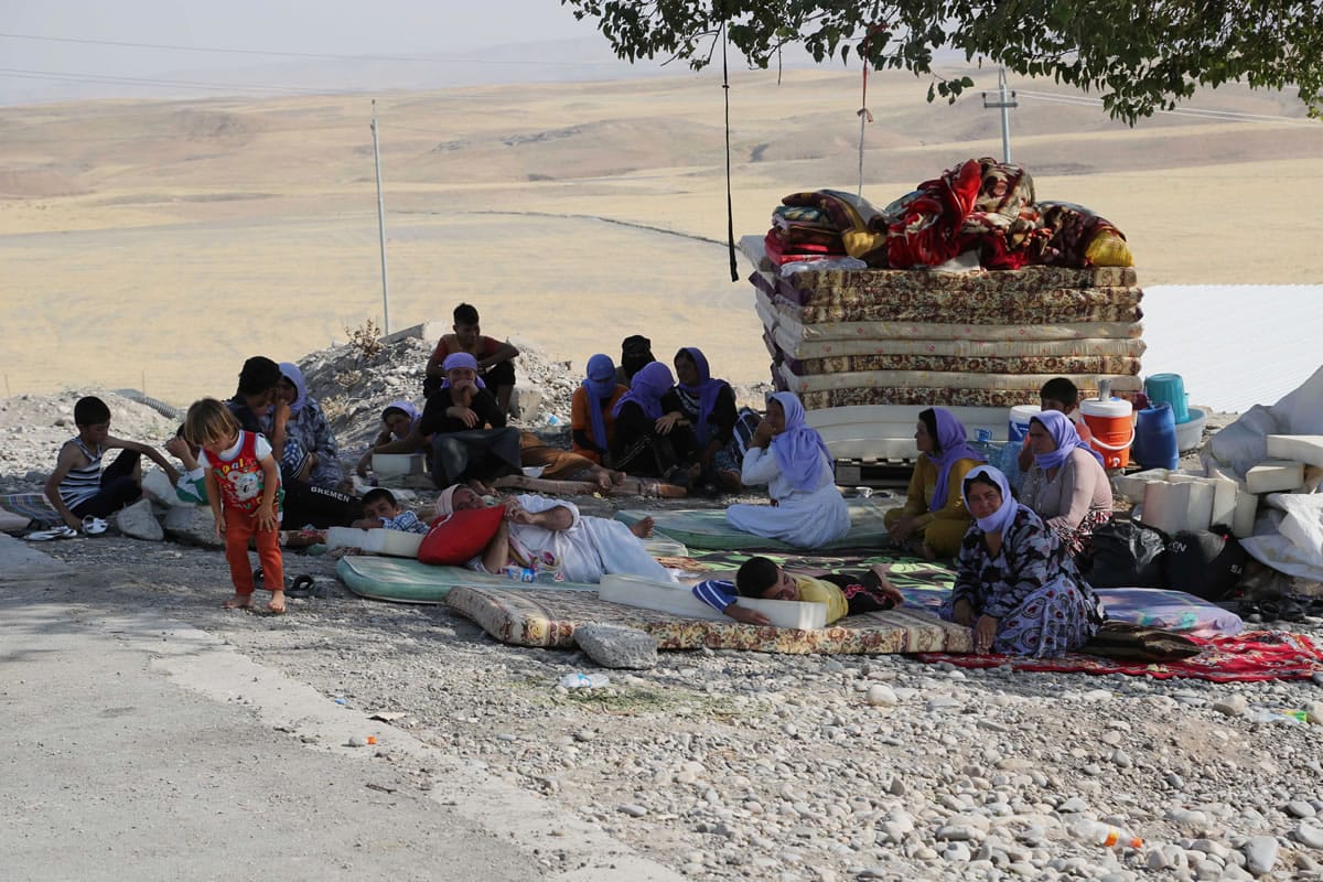 Displaced Iraqis from the Yazidi community settle at the Qandil mountains near the Turkish border outside Zakho, 300 miles northwest of Baghdad, Iraq, on Saturday.