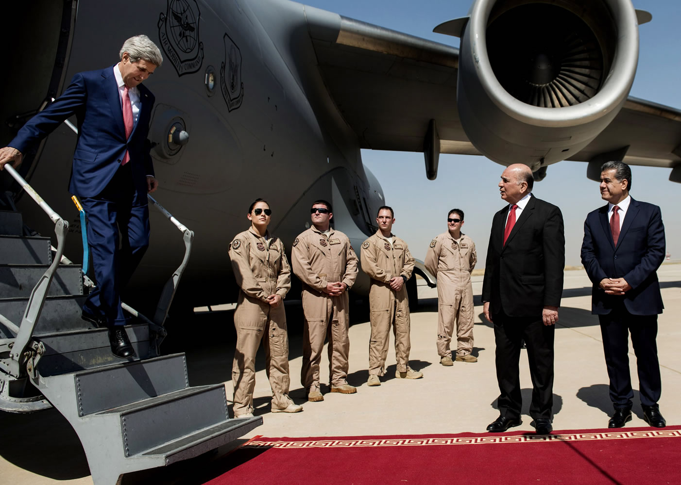 U.S. Secretary of State John Kerry, left, arrives at the airport in Irbil, Iraq, on Tuesday.