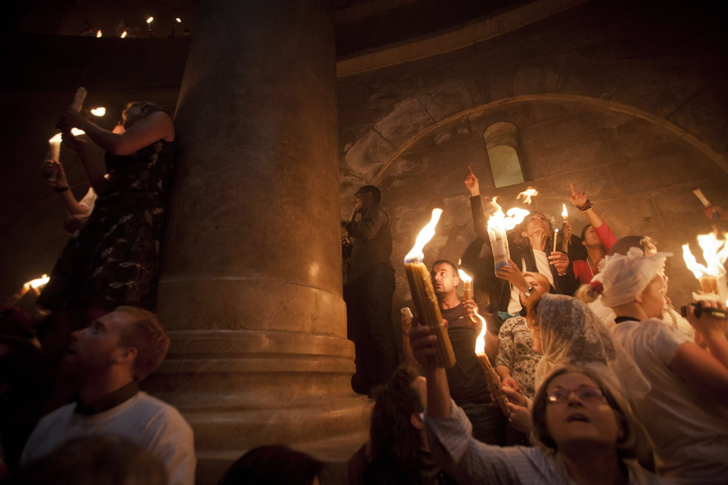 Christian pilgrims hold candles at the church of the Holy Sepulcher, traditionally believed to be the burial site of Jesus Christ, on Saturday during the ceremony of the Holy Fire in Jerusalem's Old City.