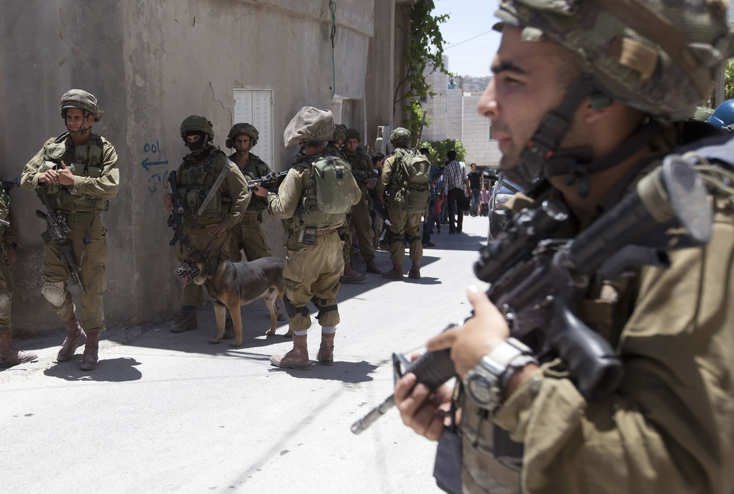 Israeli soldiers patrol Sunday during a military operation to search for three missing teenagers outside the West Bank city of Hebron.