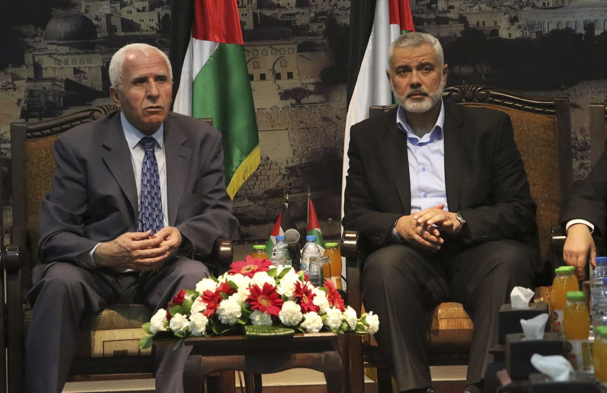 Gaza's Hamas Prime Minister Ismail Haniyeh, right, and senior Fatah official Azzam al-Ahmad meet in Gaza for talks aimed at reaching a reconciliation agreement between the two rival Palestinian groups, Hamas and Fatah, on Tuesday.