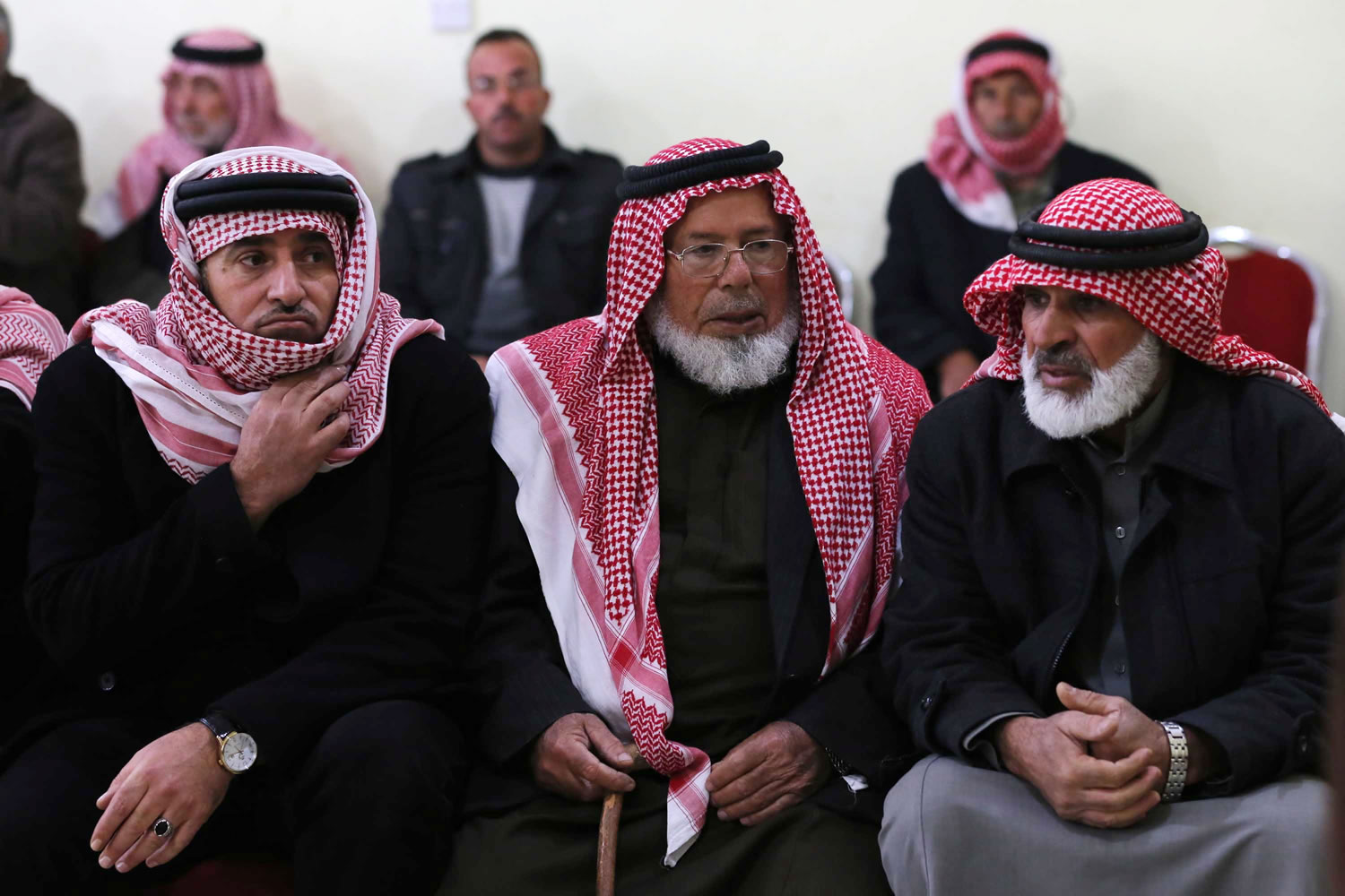 Friends and relatives of Mu'ath Safi al-Kaseasbeh, a Jordanian pilot captured by the Islamic State group, gather in the town of Aey near Al Karak in southern Jordan on Wednesday.
