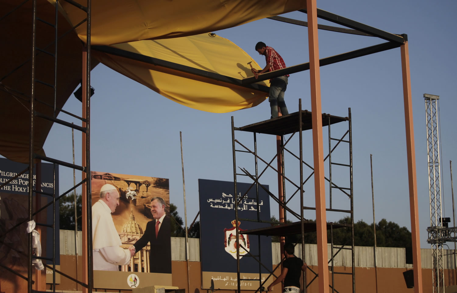 Workers make final preparations Thursday ahead of Saturday's Mass that will be conducted by Pope Francis at Amman International Stadium in Jordan.