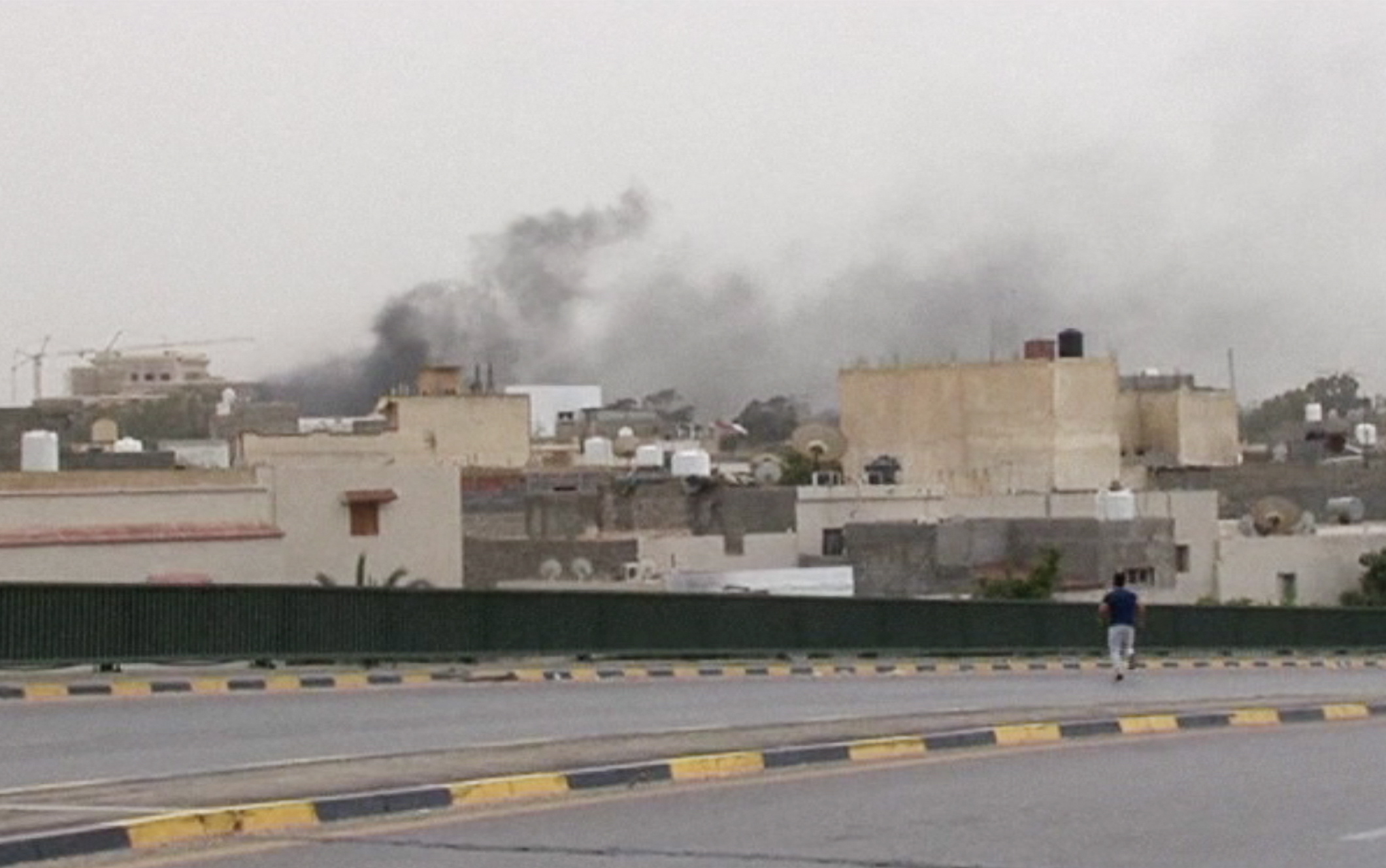 In this image made from video provided by the Libyan national army via AP Television, smoke rises over the parliament area after troops of Gen.