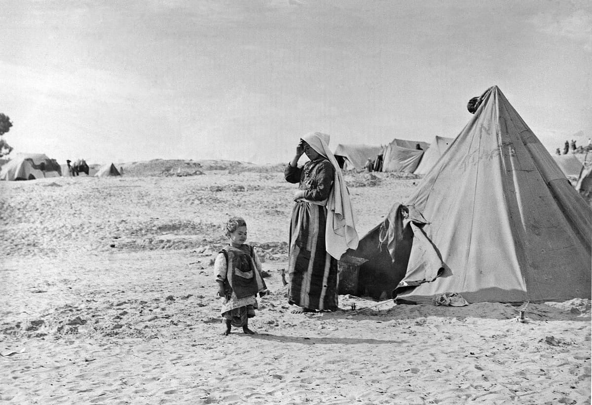 UNRWA Photo Archives
Above, Palestinian refugees stand outside their tent in Khan Younis, Gaza Strip in 1948.