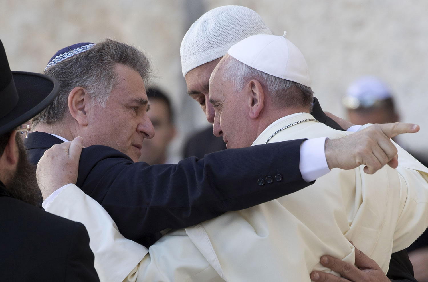 Pope Francis, right, embraces two good friends -- Argentine Rabbi Abraham Skorka, left, and Omar Abboud, leader of Argentina's Muslim community -- Monday as he visits the Western Wall in Jerusalem's Old City.