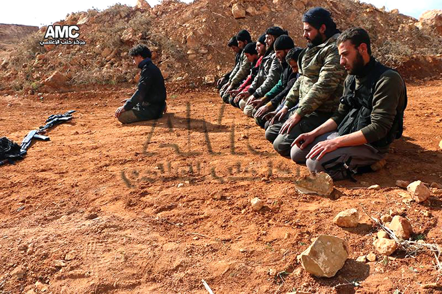 Syrian rebels pray at the frontline of Sheikh Najjar village, in Aleppo, Syria.