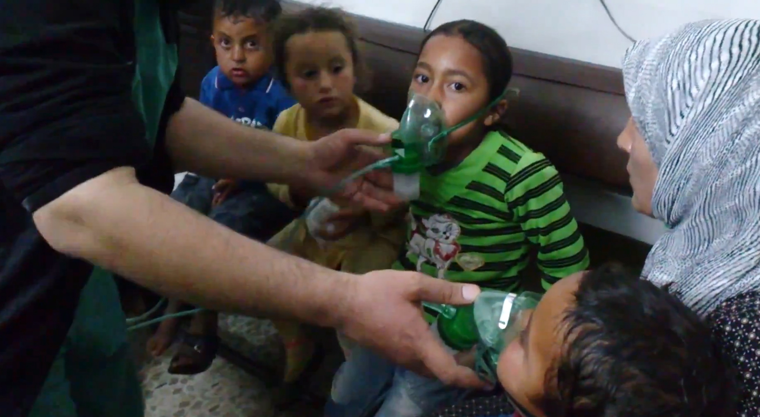 In this image from video obtained from an anti-government activist group on April 16, children receive oxygen in Kfar Zeita, a rebel-held village in Hama province some 125 miles north of Damascus.