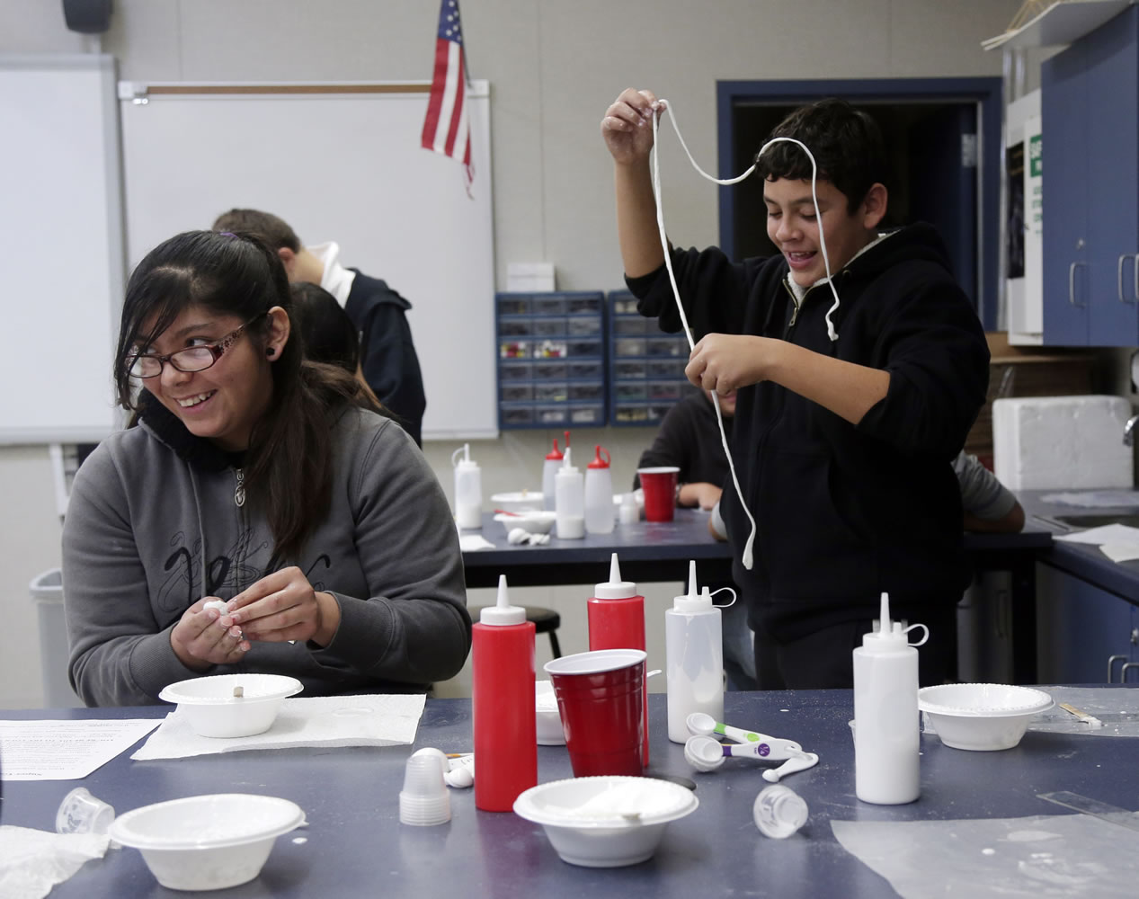 Claudia Morales, left, 13, jokes with classmate Chris Rocha during a science class this month at Palo Verde Union School in Tulare, Calif.