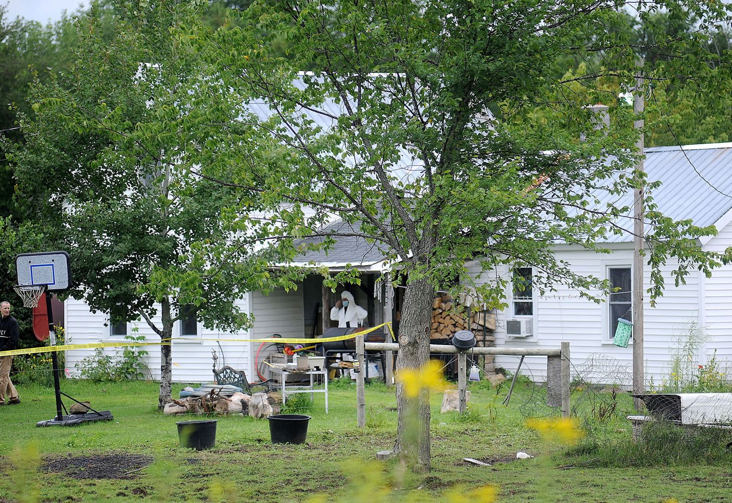 A New York State Police crime scene investigator walks out the home of Stephen Howells II and Nicole F. Vaisey, in Hermon, N.Y., on Saturday.