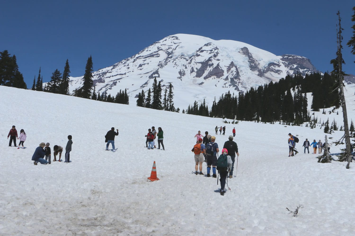 Visitors hike through the snow Sunday at the trails that start from Mount Rainier's Paradise Visitor Cente.