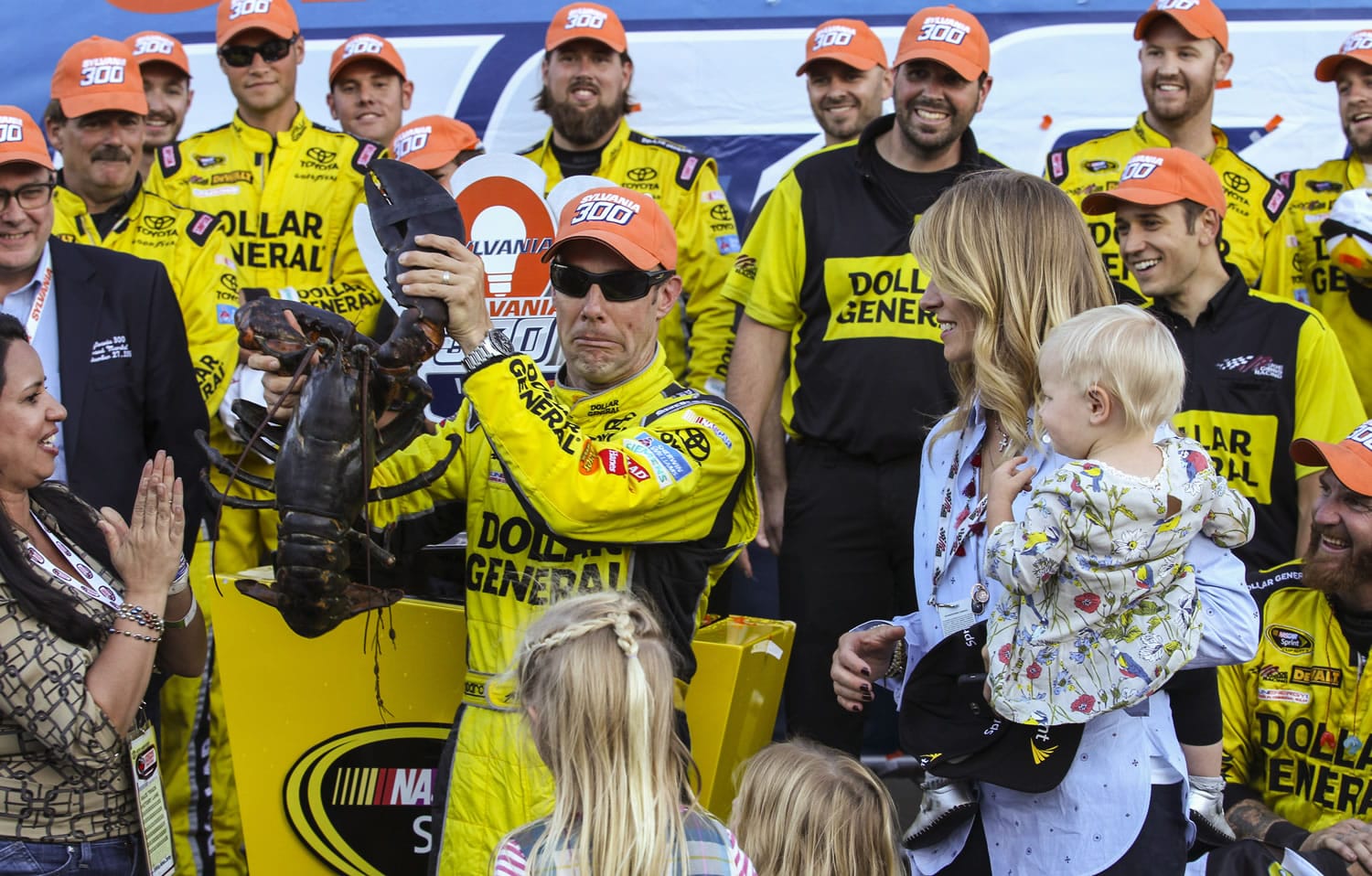 Matt Kenseth holds a lobster in Victory Lane after winning the NASCAR Sprint Cup series auto race at New Hampshire Motor Speedway in Loudon, N.H., Sunday, Sept. 27, 2015.