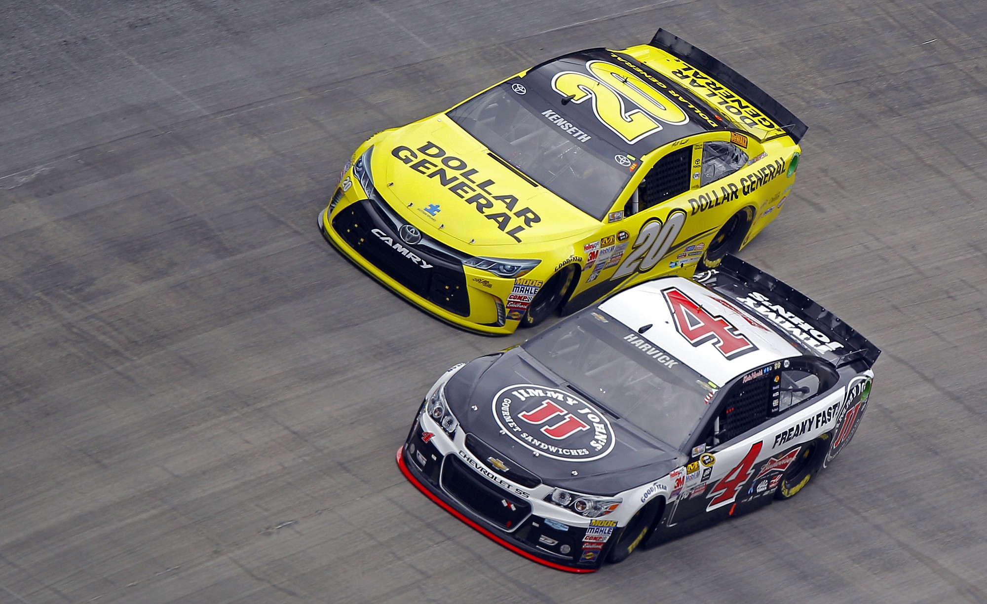 Driver Kevin Harvick (4) passes Matt Kenseth (20) to take the lead during the NASCAR Sprint Cup Series auto race at Bristol Motor Speedway on Sunday, April 19, 2015, in Bristol, Tenn.