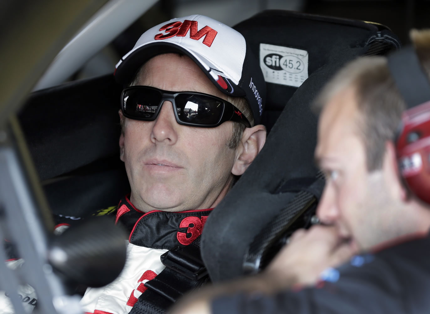 Greg Biffle, left, talks to a crew member before a NASCAR Sprint Cup series auto race practice at Darlington Speedway in Darlington, S.C., Friday.