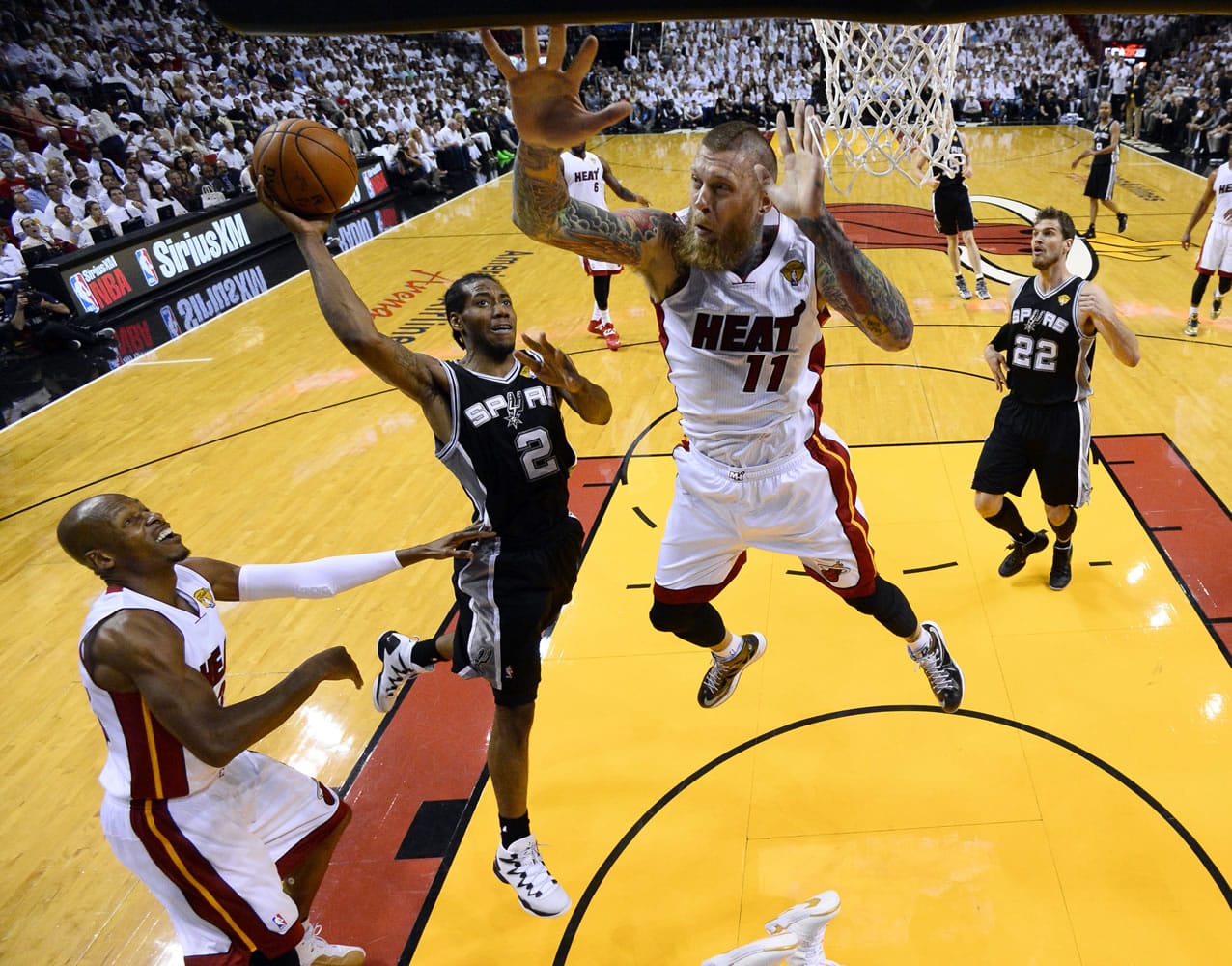 San Antonio Spurs forward Kawhi Leonard (2) goes to the basket as Miami Heat forward Chris Andersen (11) defends in the first half in Game 4 of the NBA basketball finals in Miami, Thursday, June 12, 2014. The Spurs won 107-86. (AP Photo/Larry W.