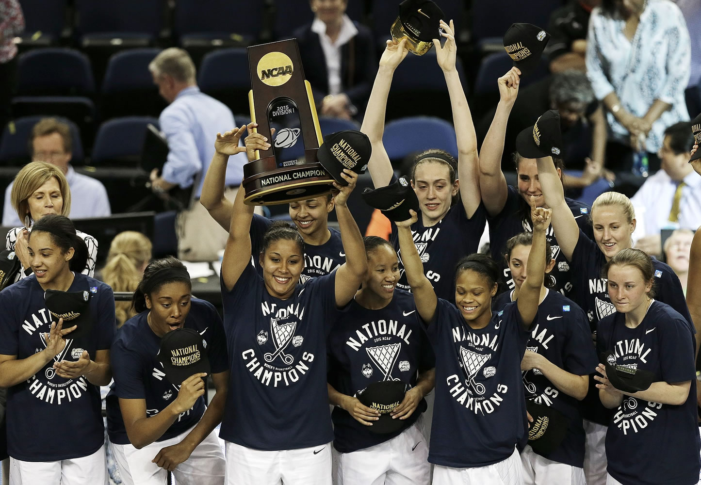Connecticut players pose with the national championship trophy after the NCAA women's Final Four tournament college basketball championship game against Notre Dame, Tuesday, April 7, 2015, in Tampa, Fla. Connecticut won 63-53.