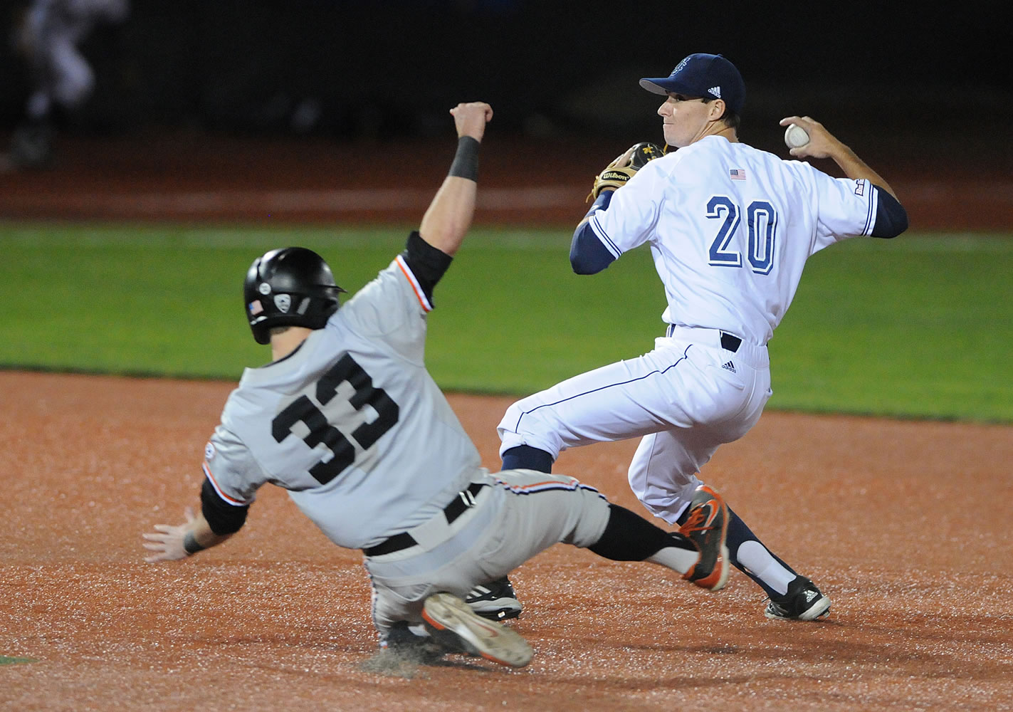 UC Irvine's John Brontsema turns a double play over Oregon State's Logan Ice to win the NCAA college baseball regional tournament in Corvallis, Ore., Monday, June 2, 2014.
