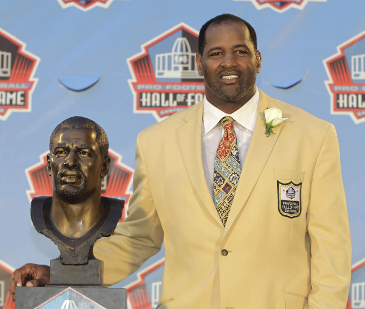 Richard Dent poses with a bust of himself during induction ceremonies at the Pro Football Hall of Fame on Aug.