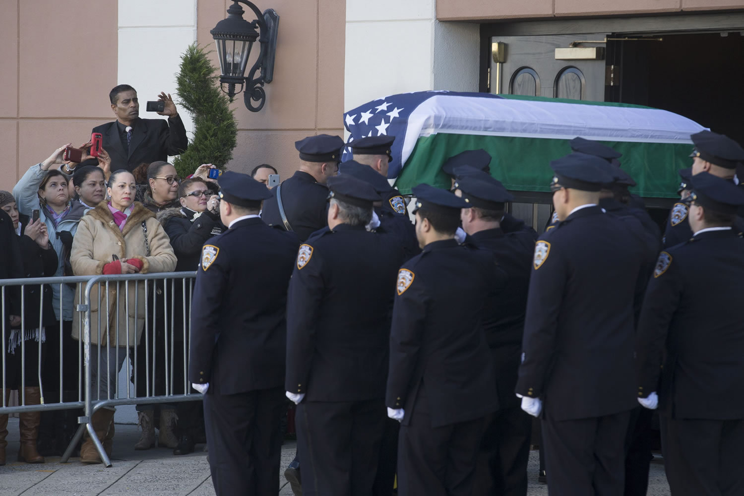 The casket of New York Police Department Officer Rafael Ramos arrives Friday to his wake at Christ Tabernacle Church in the Glendale section of Queens, where he was member, in New York. Ramos was killed Dec. 20 along with his partner, Officer Wenjian Liu, as they sat in their patrol car on a Brooklyn street. The shooter, Ismaaiyl Brinsley, later killed himself.