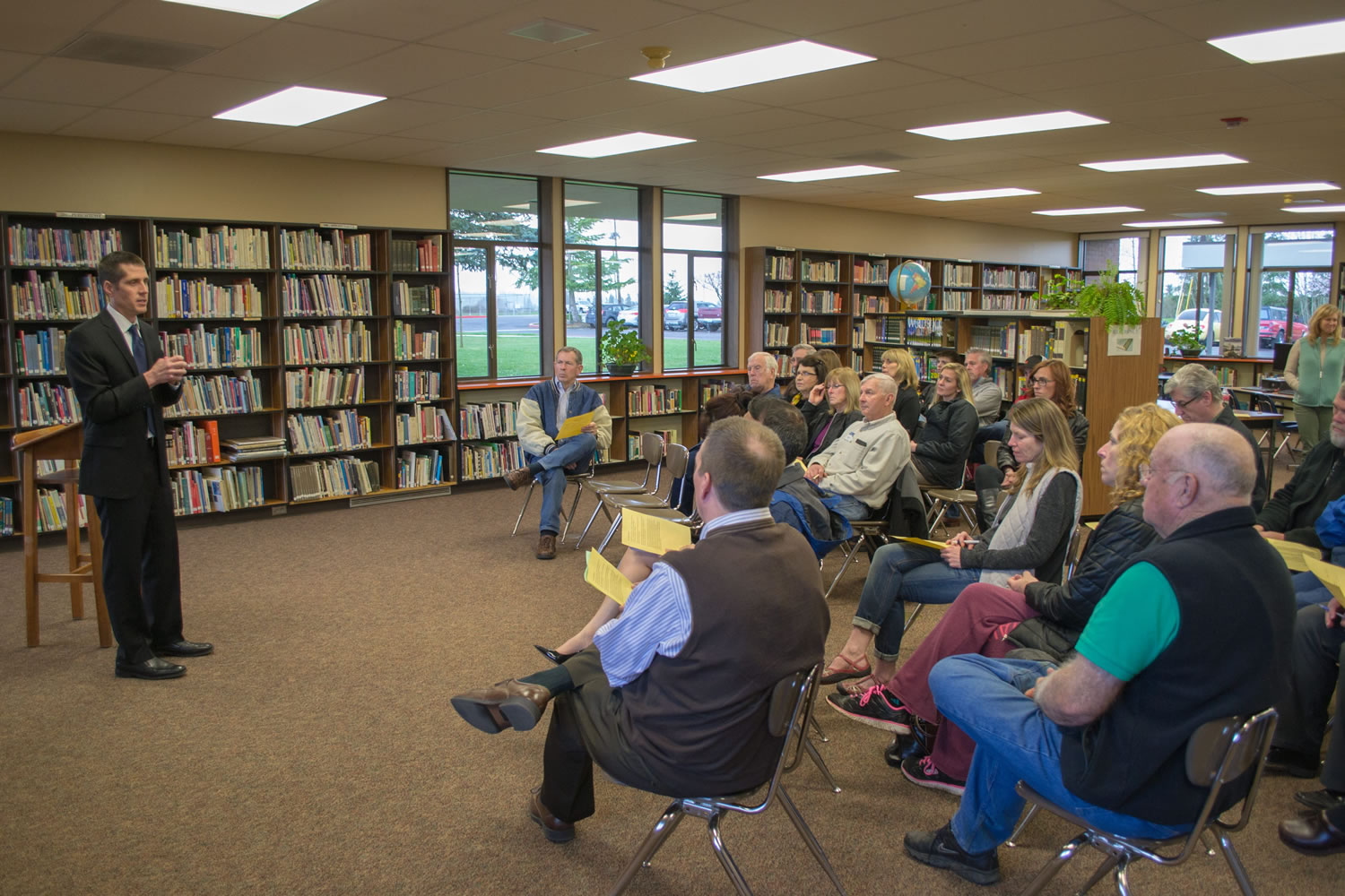 Nathan McCann, left, speaks with the local community during a forum in the Ridgefield High School library before getting the job.