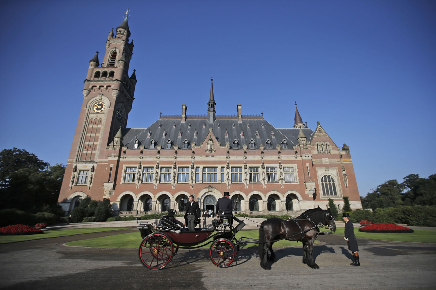 A horse-drawn carriage stands in front of the Peace Palace, seat of the International Court of Justice in The Hague, Netherlands.
