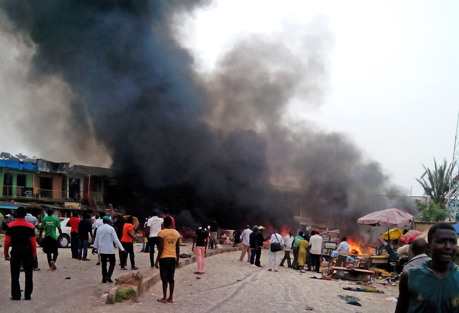 Smoke rises after a bomb blast at a bus terminal in Jos, Nigeria on Tuesday. Two explosions ripped through a bustling bus terminal and market frequented by thousands of people in Nigeria's central city of Jos on Tuesday afternoon, and police said there are an unknown number of casualties.