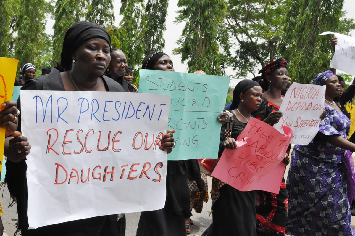 Unidentified mothers call for the president to help, during a demonstration with others who have daughters among the kidnapped school girls of government secondary school Chibok, Tuesday April 29, 2014, in Abuja, Nigeria.  Two weeks after Islamic extremists stormed a remote boarding school in northeast Nigeria, more than 200 girls and young women remain missing despite a ihot pursuiti by security forces and desperate parents heading into a dangerous forest in search of their daughters. Some dozens have managed to escape their captors, jumping from the back of an open truck or escaping into the bush from a forest hideout, although the exact number of escapees is unclear.