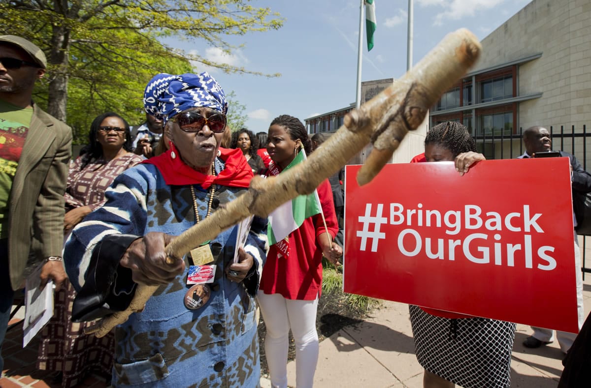 Mia Kuumba, of the District of Columbia, brandishes a wooden stick during a rally in front of the Nigerian embassy in northwest Washington on Tuesday, protesting the kidnapping of nearly 300 teenage schoolgirls, abducted from a school in the remote northeast of Nigeria three weeks ago.