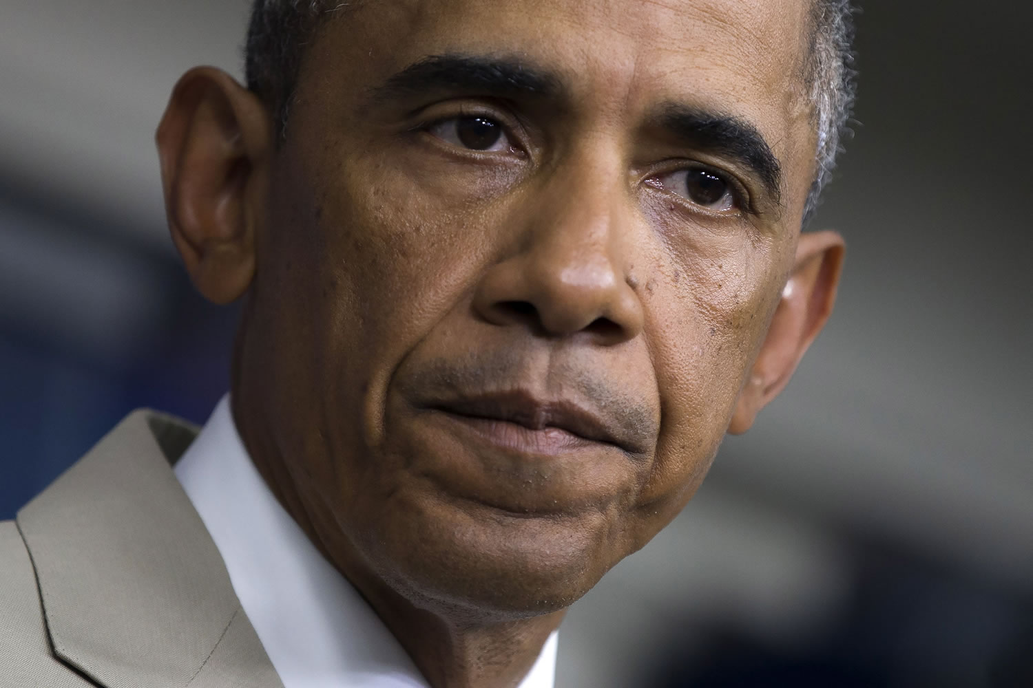 President Barack Obama listens in the James Brady Press Briefing Room of the White House in Washington on Thursday, Aug.