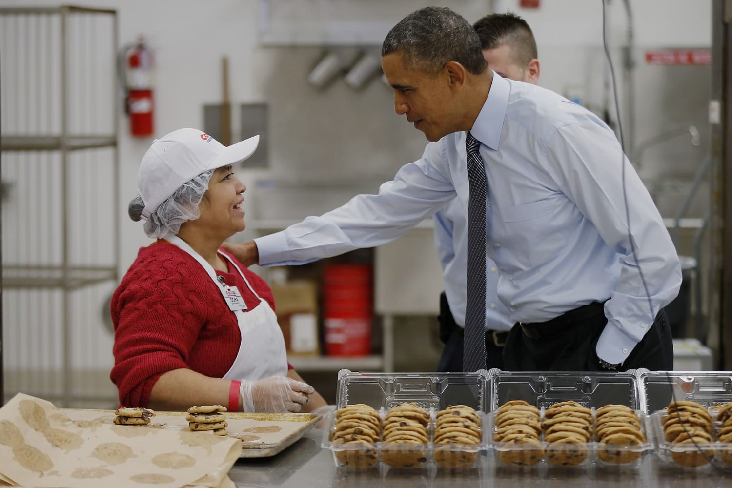 President Barack Obama greets an employee in the bakery at a Costco store Wednesday in Lanham, Md.