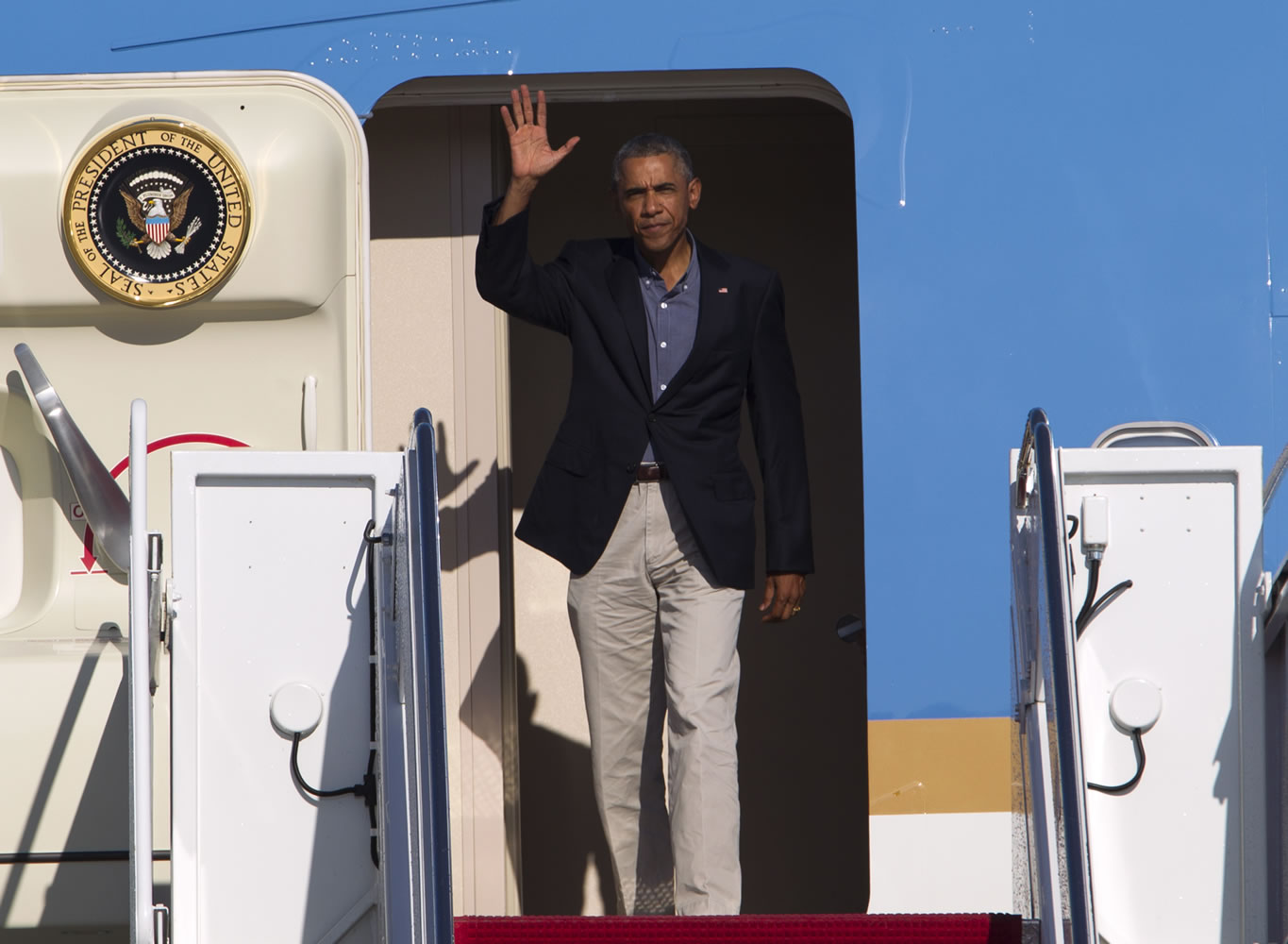 President Barack Obama waves from Air Force One upon arrival at Andrews Air Force Base, Md., on Monday.