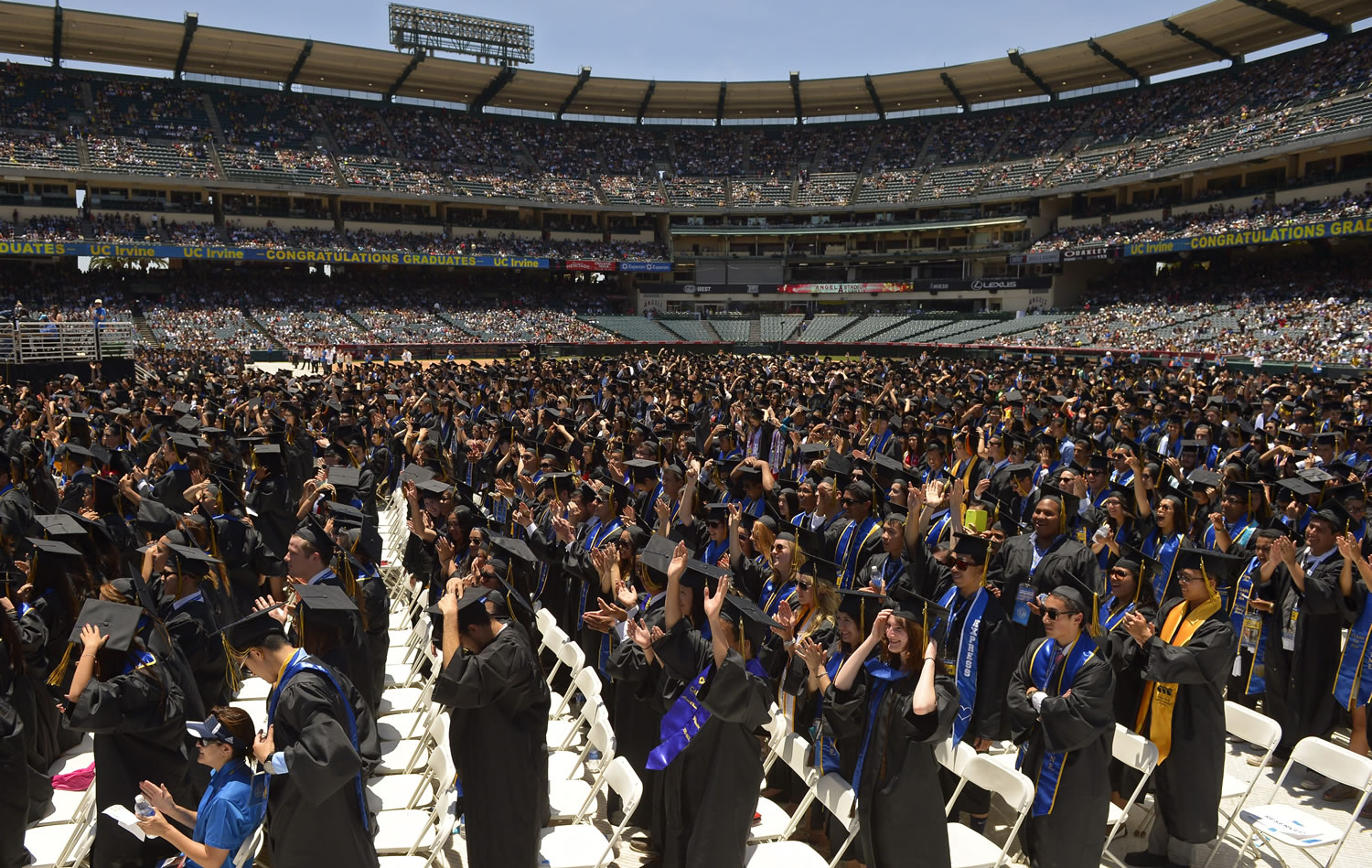 Students move their tassels from right to left following President Barack Obama's commencement address Saturday for the University of California, Irvine in Anaheim, Calif.