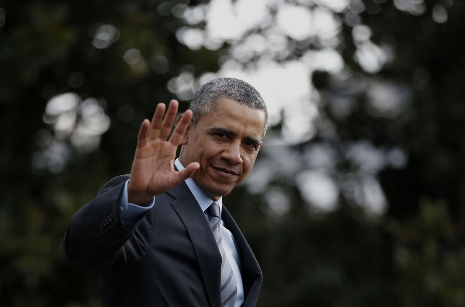 President Barack Obama waves to reporters as he walks on the South Lawn of the White House in Washington on Wednesday before boarding the Marine One helicopter to Andrews Air Force Base, Md., for his trip to Mexico.