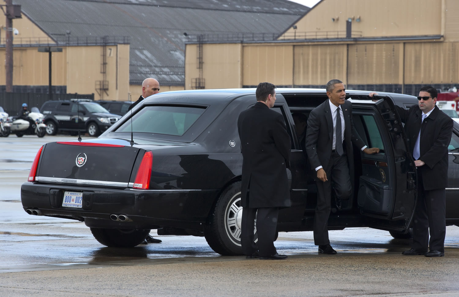 President Barack Obama arrives via motorcade in a light snow on Wednesday at Andrews Air Force Base, Md., before boarding Air Force One for a trip to St.