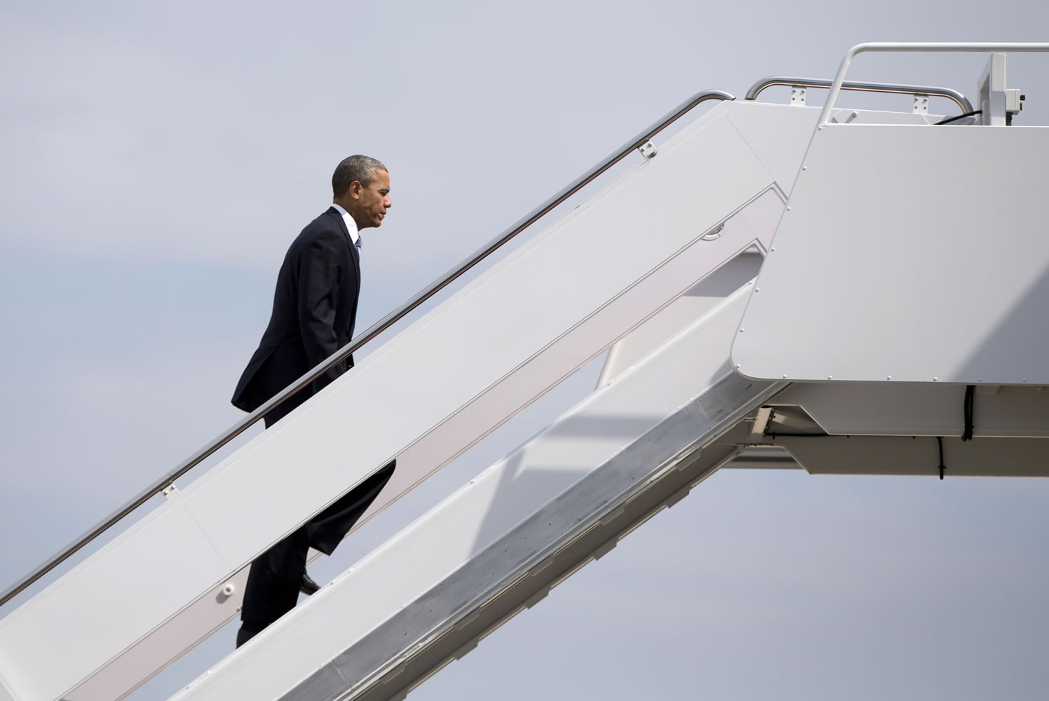President Barack Obama boards Air Force One on Tuesday at Andrews Air Force Base, Md., en route to Oso, the site of the deadly mudslide that struck the community.