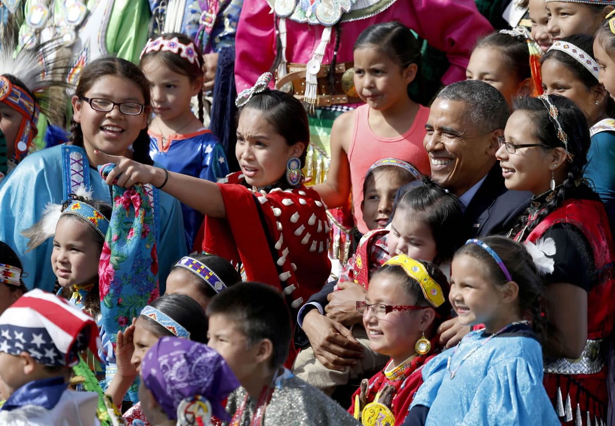 President Barack Obama poses with Native American dancers during his visit to the Standing Rock Indian Reservation on Friday in Cannon Ball, N.D.
