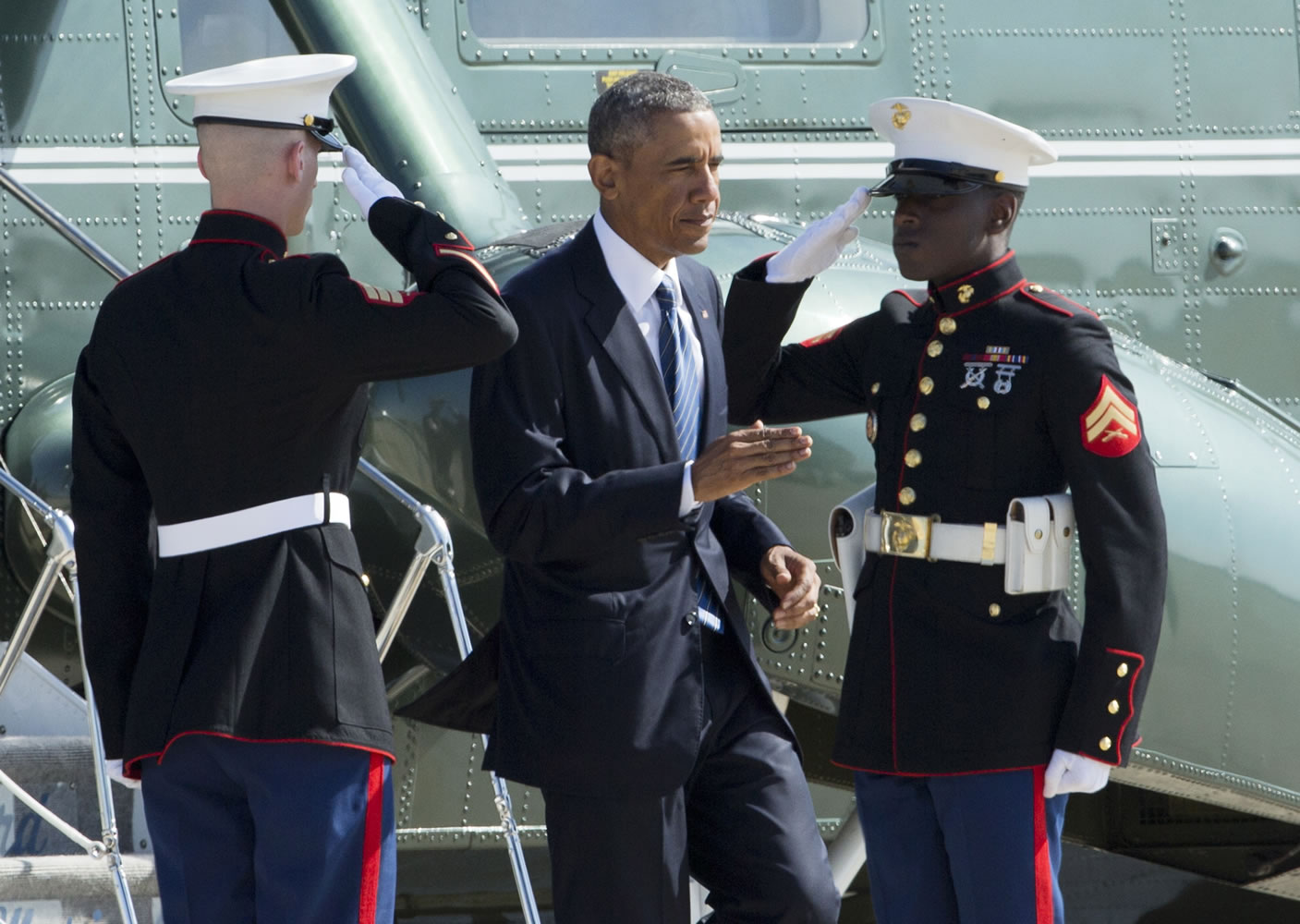 President Barack Obama returns a salute at Marine honor guards as he disembarks Marine One to switch to Air Force One at Andrews Air Force Base, Md., on Tuesday.