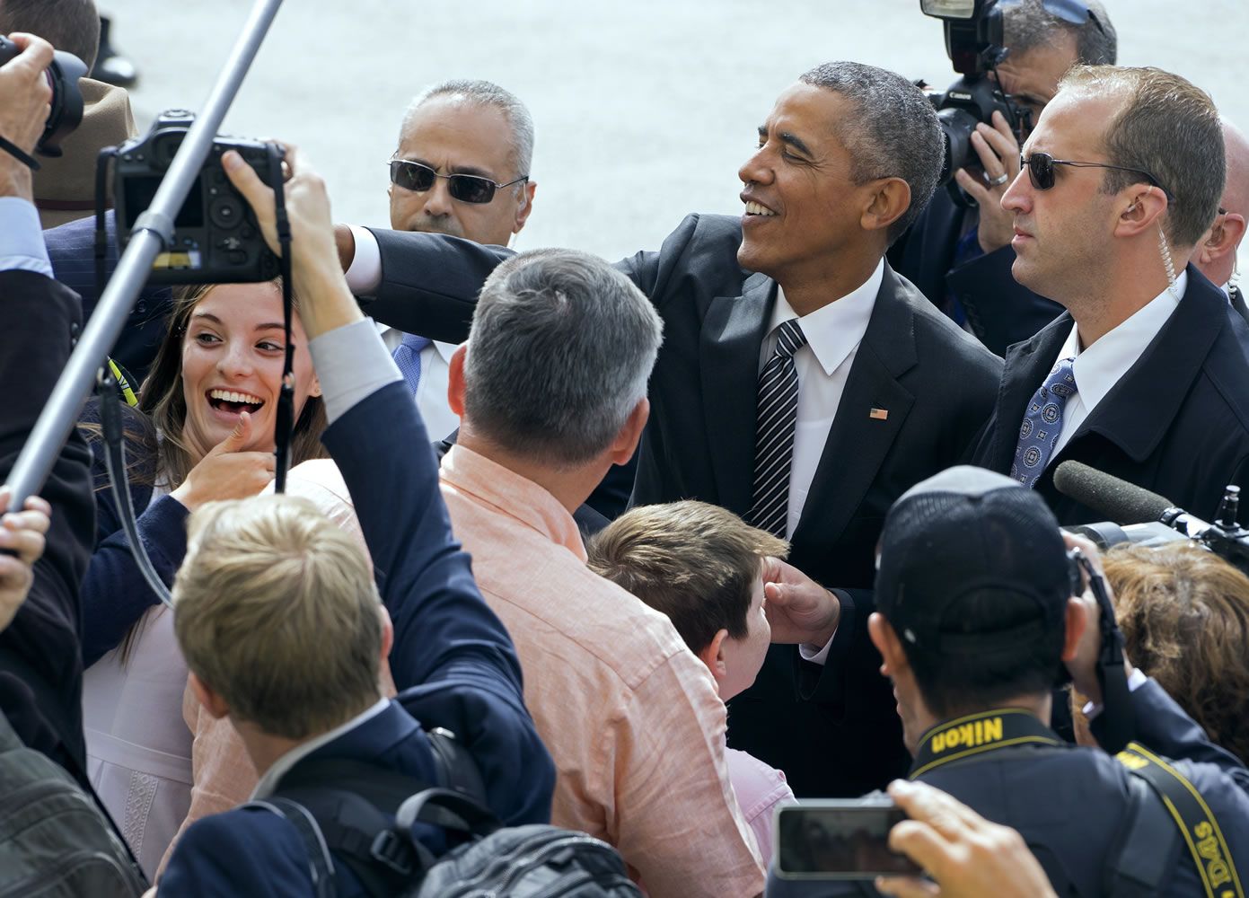 President Barack Obama greets guests Sunday after arriving at John F. Kennedy International Airport in New York.