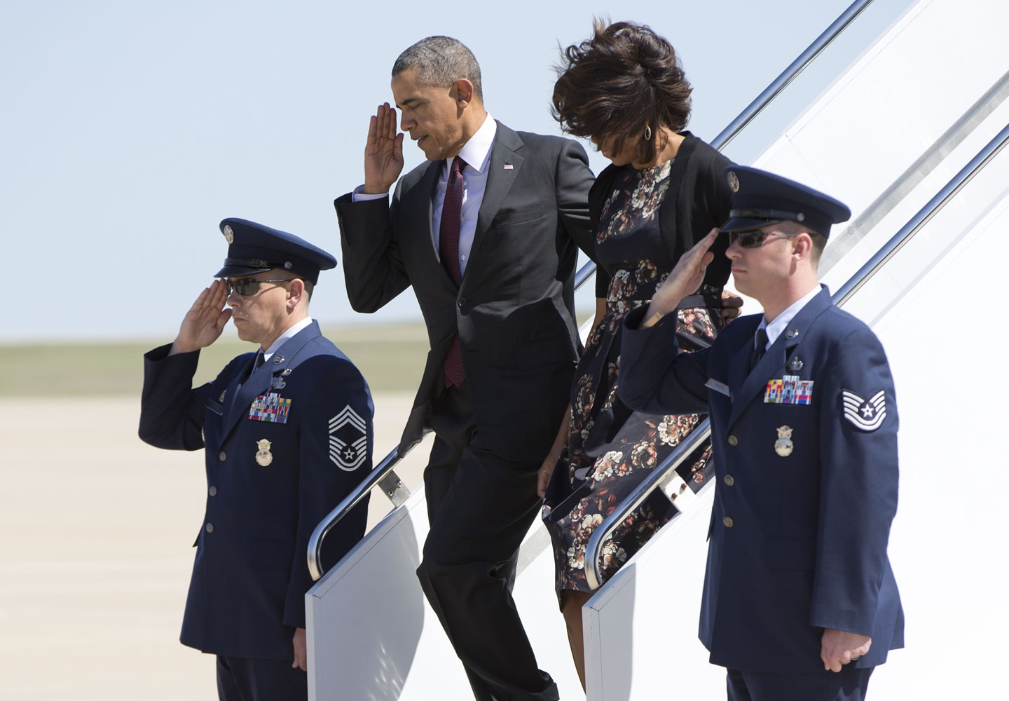President Barack Obama salutes as he and and first lady Michelle Obama arrive on Air Force One at Robert Gray Army Air Field on Wednesday in Killeen, Texas, as they travel to Fort Hood for a memorial service for those killed there in a shooting last week.