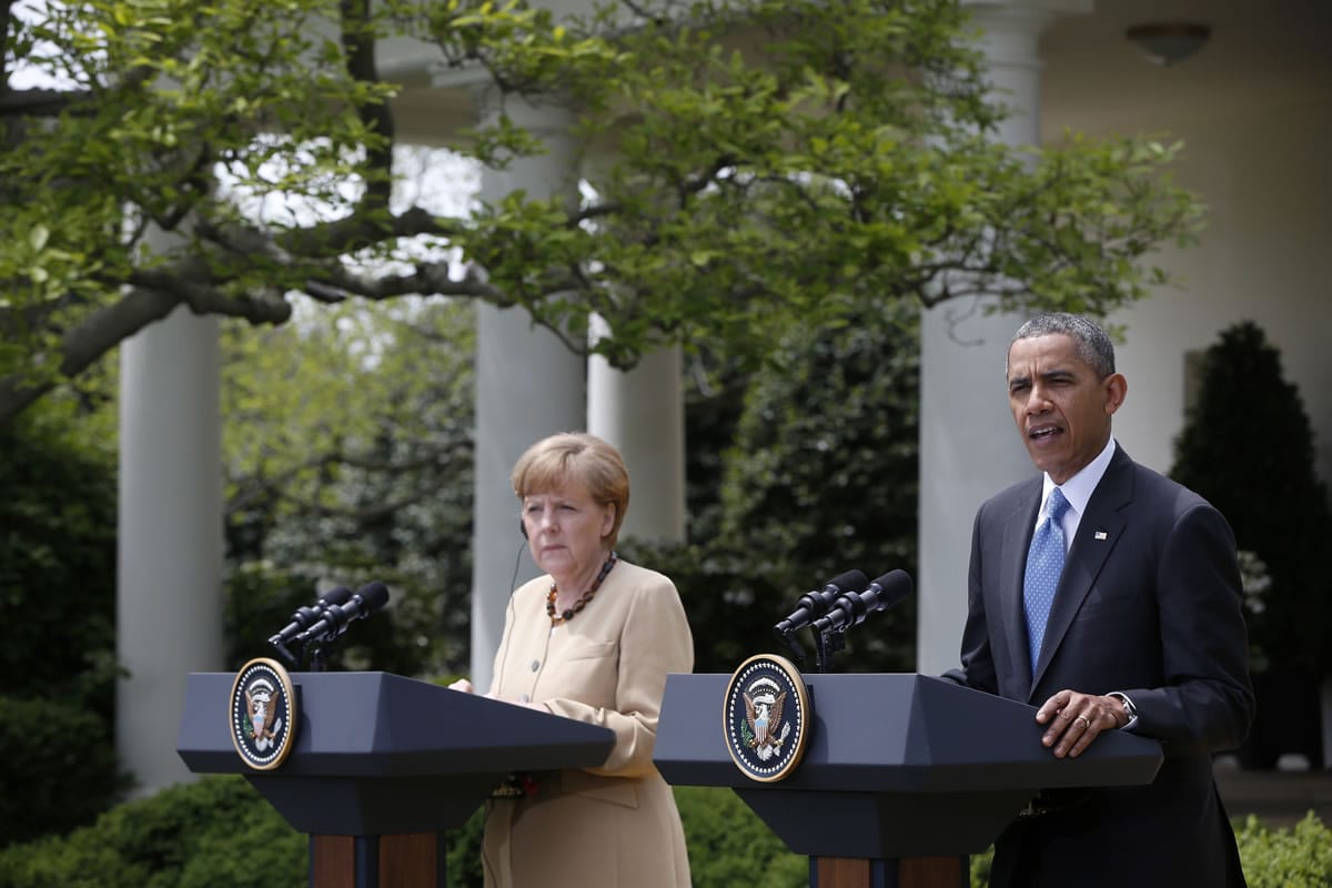 President Barack Obama and German Chancellor Angela Merkel participate in a joint news conference in the Rose Garden of the White House in Washington on Friday.