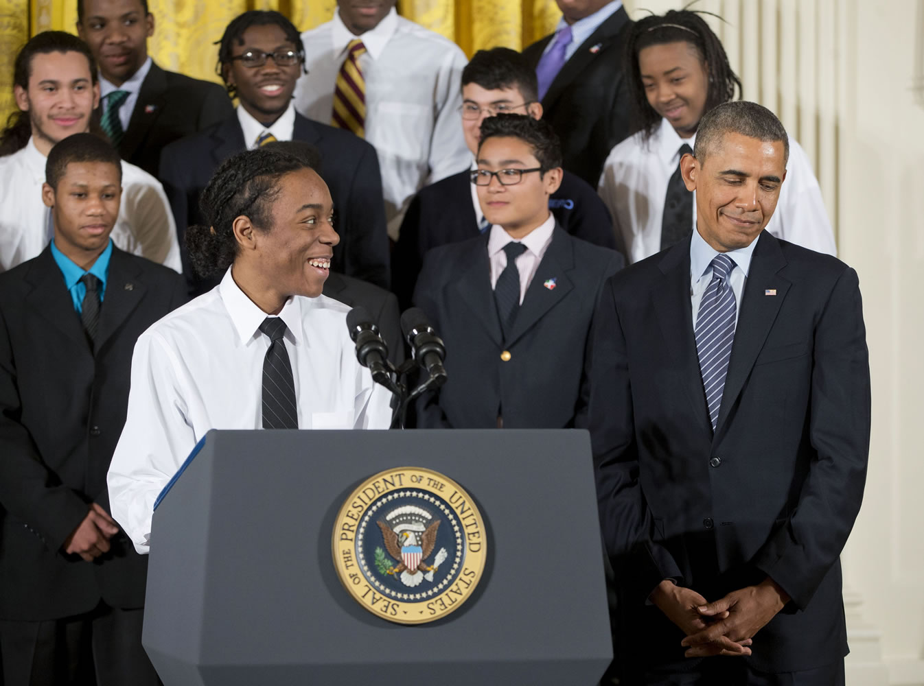 President Barack Obama is introduced by Christian Champagne, 18, a senior at Hyde Park Career Academy in Chicago, before speaking about his new initiative to provide greater opportunities for young black and Hispanic men called &quot;My Brother's Keeper&quot; on Thursday at the White House.