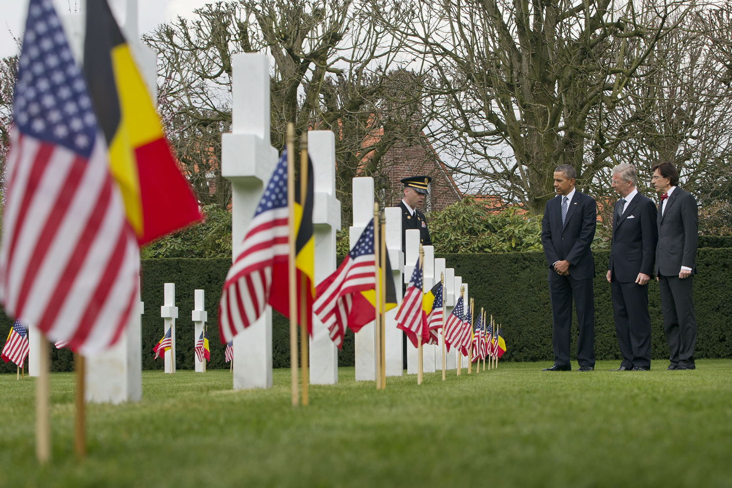 US President Barack Obama, third right, tours the American cemetery at Flanders Field with Belgian King Phillippe and Belgian Prime Minister Elio Di Rupo, far right, in Waregem, Belgium, on Wednesday.
