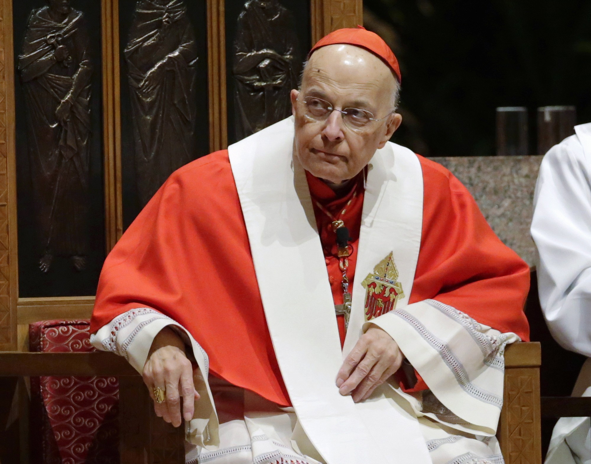 Retiring Cardinal Francis George listens Nov. 17, 2014, at Holy Name Cathedral in Chicago during Bishop Blase Cupich's Rite of Reception service. The Chicago Archdiocese announced Friday that George died after a long bout with cancer. He was 78.