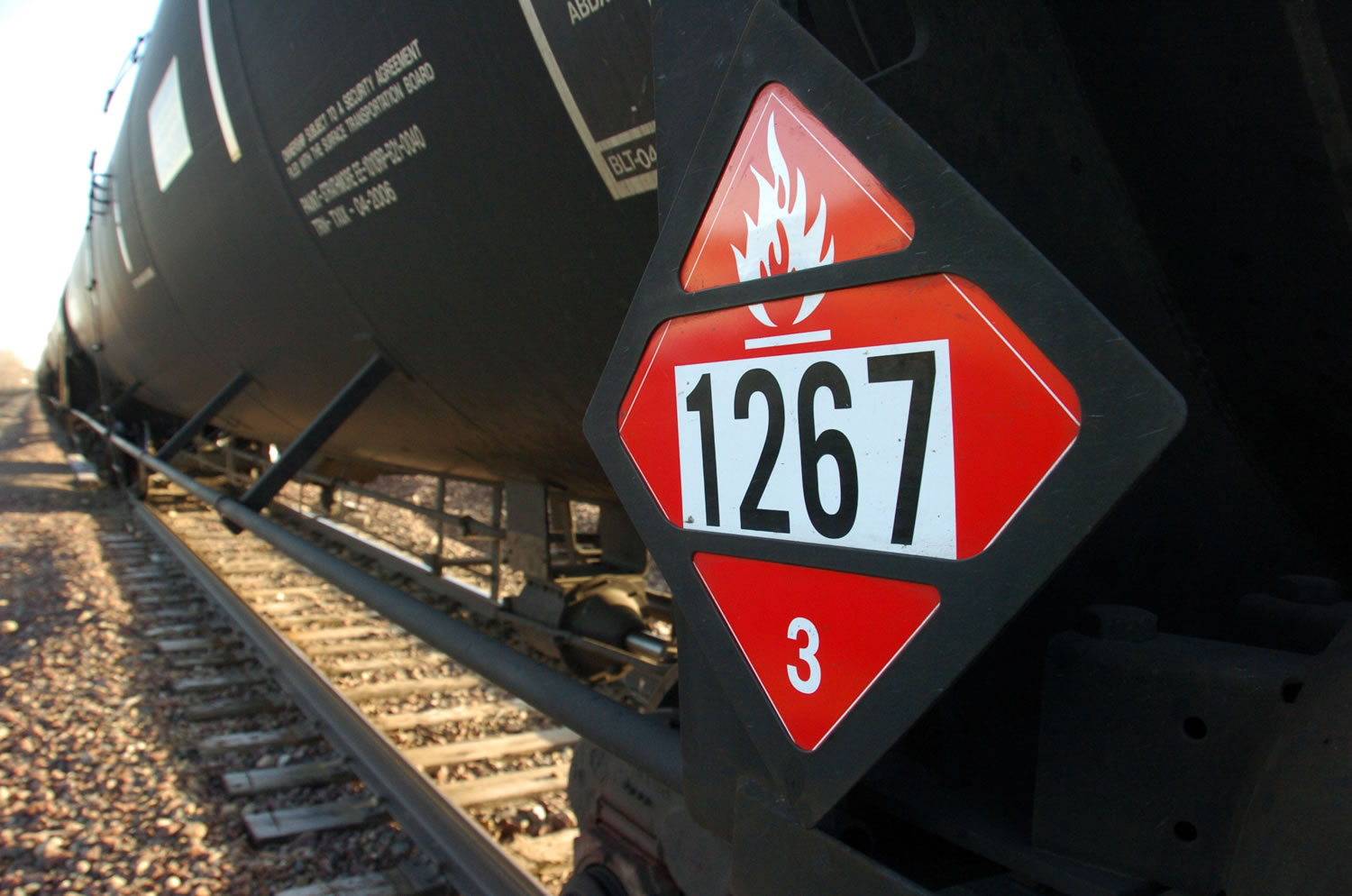 A warning placard appears on a tank car carrying crude oil near a loading terminal in Trenton, N.D.