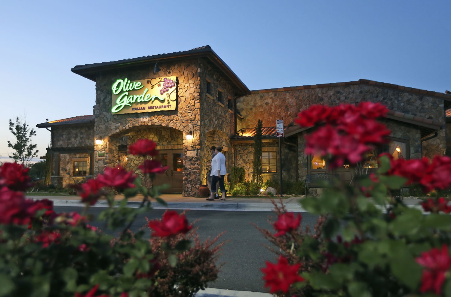 Patrons enter an Olive Garden Restaurant in Short Pump, Va. Olive Garden is hurting itself by piling on too many breadsticks, according to an investor who is disputing how the restaurant chain is run.