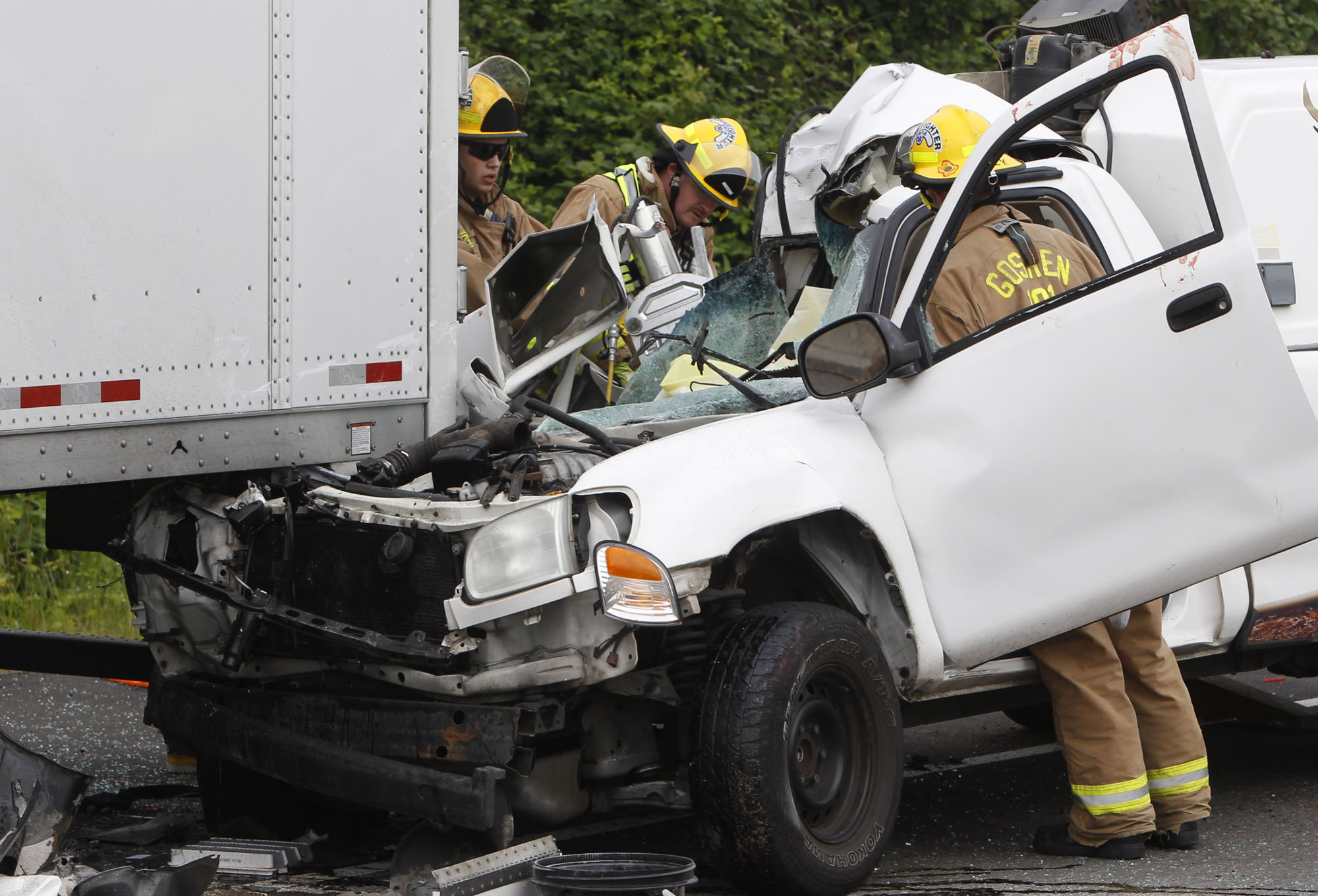 Personnel with the Goshen Fire Department work to extricate someone from a vehicle crash involving a pickup and a tractor-trailer in the southbound lanes of Interstate 5 near Highway 58 south of Eugene, Ore., on Tuesday.