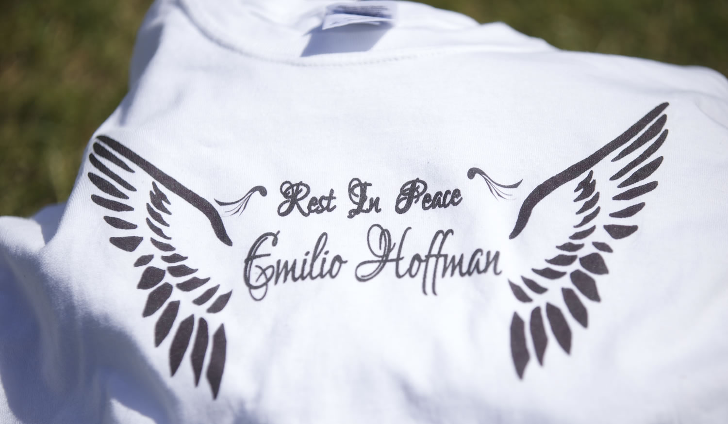 One of a stack of T-shirts, brought by a woman who didn't want to be identified, has &quot;Rest In Peace Emilio Hoffman&quot; and a pair of wings of each side on Wednesday outside Reynolds High School in Troutdale, Ore.