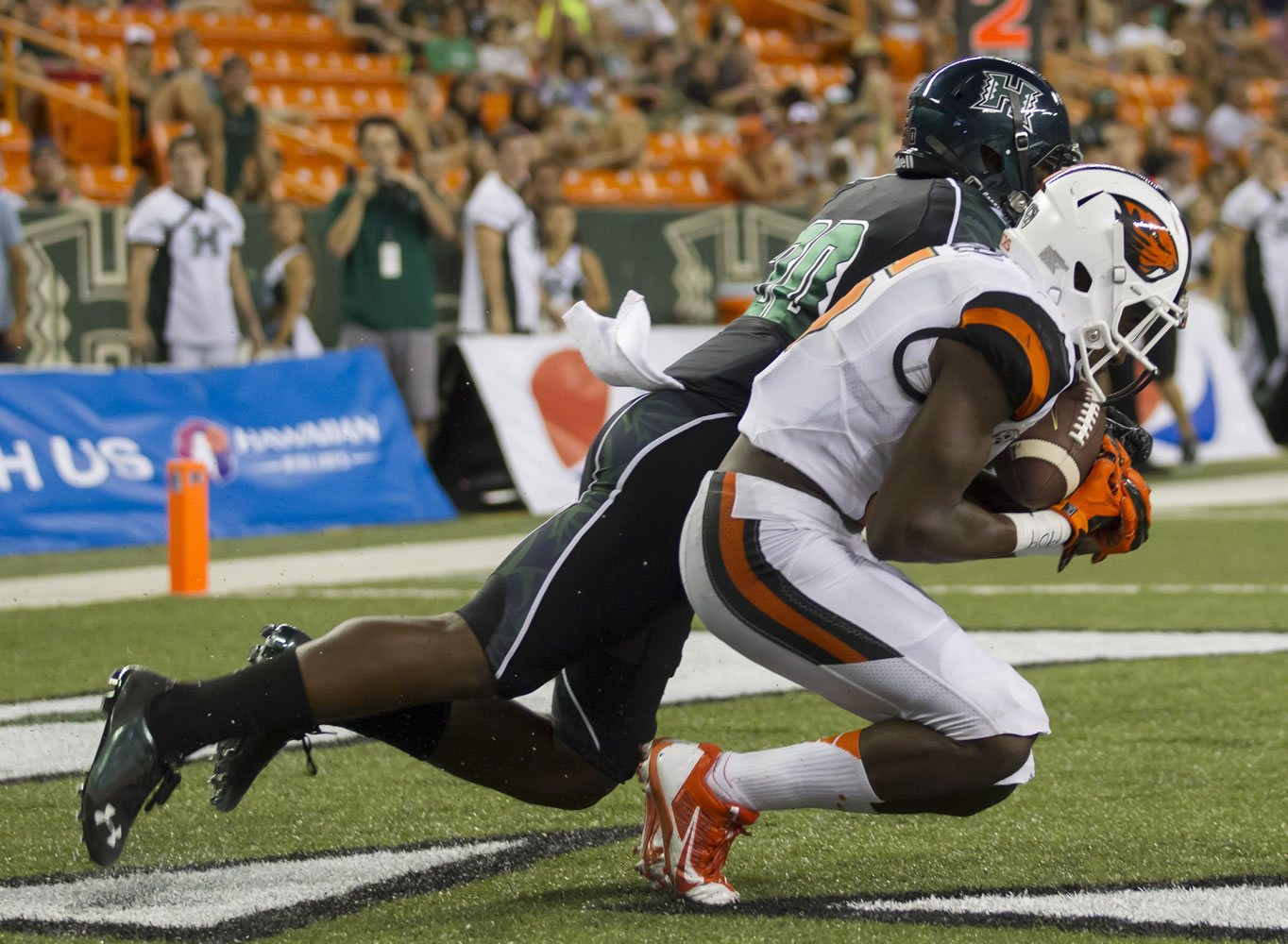 Oregon State wide receiver Victor Bolden (6) catches a pass for a touchdown while being defended by Hawaii defensive back Nick Nelson (20) in the third quarter of an NCAA college football game, Saturday, Sept. 6, 2014, in Honolulu.