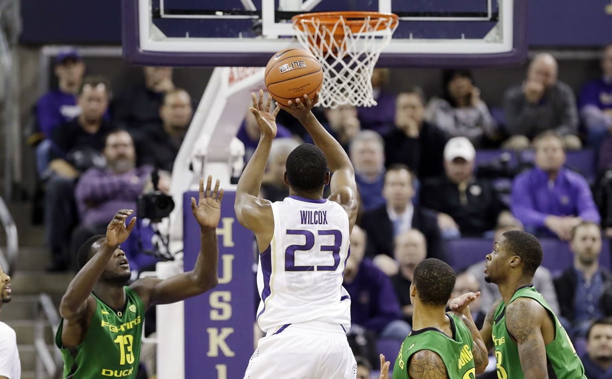 Washington guard C.J. Wilcox shoots against Oregon in the second half of an NCAA men's college basketball game Thursday, Jan. 23, 2014, in Seattle. Wilcox led all scorers with 23 points and Washington won 80-76.