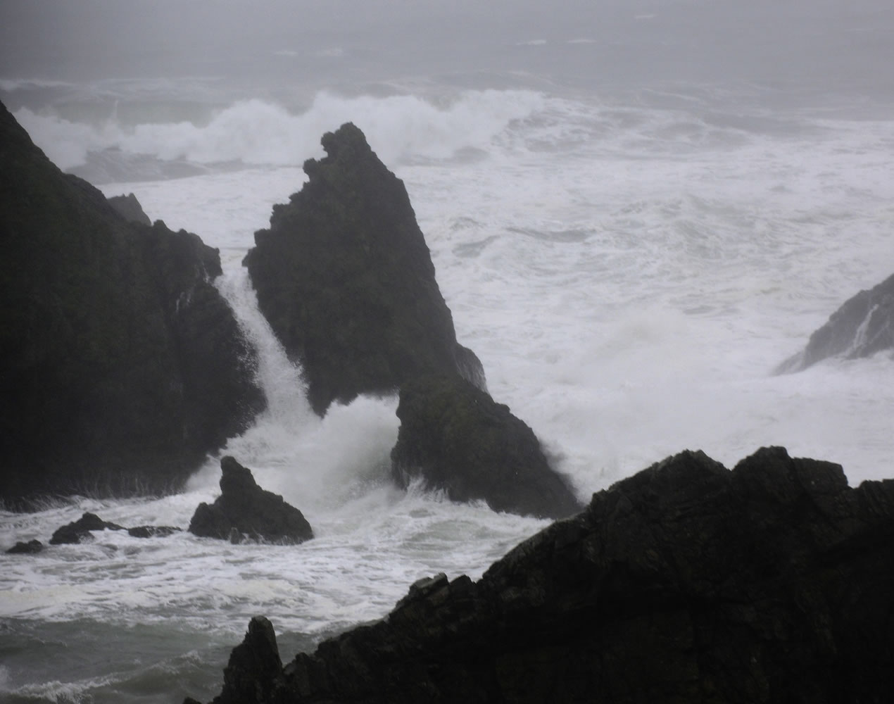 Stormy seas surge over rocks along the coast near Bandon, Ore., earlier this month.
